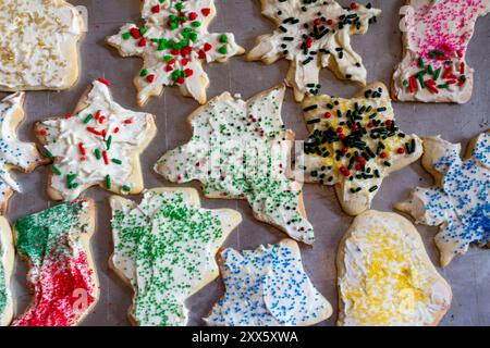 Frosted and decorated sugar cookies are on a baking sheet to dry. Stock Photo