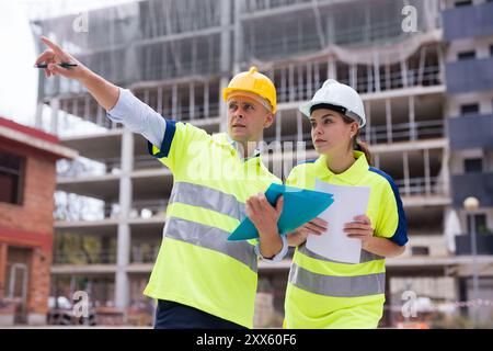 Two qualified engineers are discussing a construction plan Stock Photo