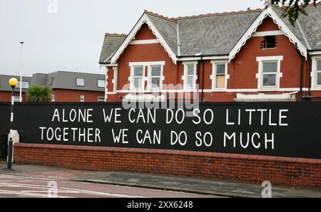 A large street sign saying ALONE WE CAN DO SO LITTLE, TOGETHER WE CAN DO SO MUCH, in Lytham St Annes, Lancashire, UNited Kingdom. Stock Photo