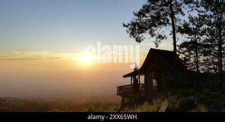 Silhouette of house and tree on sunrise in the countryside Stock Photo