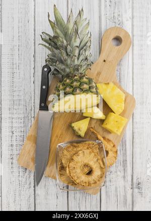 Pineapple rings (dried) on rustic wooden background as close-up shot Stock Photo