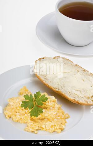 scrambled eggs and bun on a plate isolated on white Stock Photo - Alamy