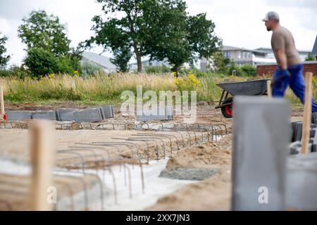 A male construction worker standing on a construction site. Family house build concept  Stock Photo