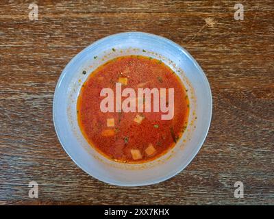 Tomato soup on white boul and wood table background Stock Photo