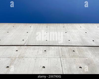 Tadao Ando's famous concrete wall against clear blue sky. Stock Photo