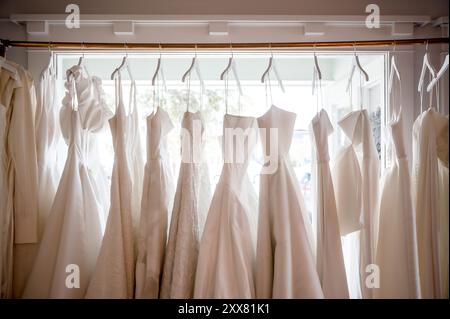Rack of bridal gowns hanging in a shop window Stock Photo