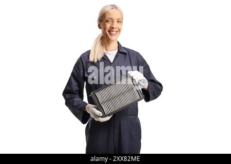 Female car mechanic holding an air filter isolated on white background Stock Photo