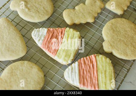 Frosted Halloween cookies on cooling rack, candy corn Stock Photo
