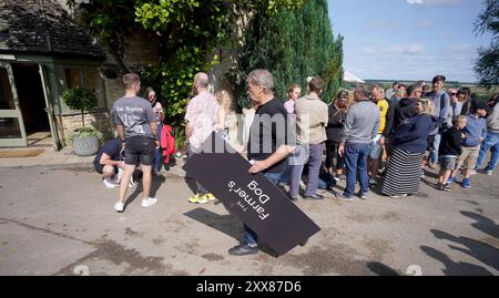 People queuing outside at the opening of Jeremy Clarkson's new pub, The Farmer's Dog, in Asthall, near Burford in Oxfordshire. Picture date: Friday August 23, 2024. Stock Photo