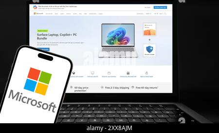 Istanbul, Turkey - 20 Aug 2024: Microsoft logo on a smartphone screen with its website in background. Microsoft is known for software like Windows and Stock Photo