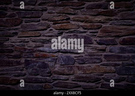 Dark wall texture. Black night stone wall background. Stock Photo