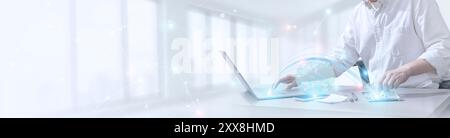 Businessman uses laptop and synchronizes business data on computer device with global network, data exchange, information transfer, data analytics and Stock Photo
