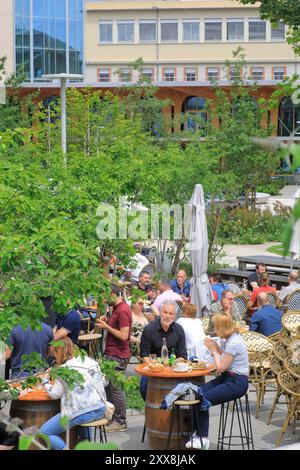 France, Puy de Dome, Clermont Ferrand, Place des Carmes, restaurant terrace with the Michelin world headquarters in the background Stock Photo