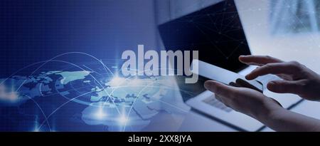A businessman is working at a computer, holding a phone in his hands and looking at something on its screen. This scene serves as a web banner with a Stock Photo