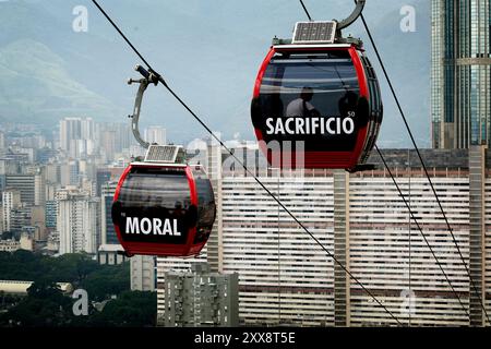 The Metro Cable cable car system runs on top of the San Augustin barrio in Caracas. The cars are all decorated with socialistic slogans. Stock Photo