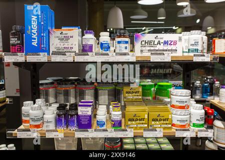 Different types of vitamins and nutritional supplements on shelves in a pharmacy or sports nutrition store. Minsk, Belarus - August 23, 2024 Stock Photo