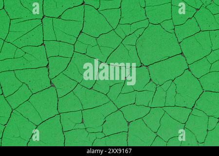Green grunge surface background. Retro style texture of paint cracks. Distressed cracked paint grungy background surface. Stock Photo