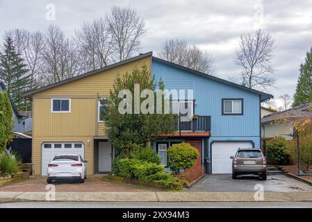 Duplex residential house with cars parked in front on autumn season in British Columbia Stock Photo