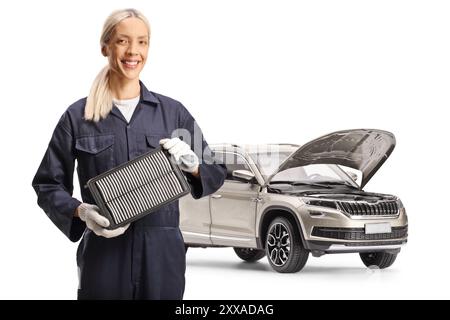 Female car mechanic holding a suv air filter isolated on white background Stock Photo