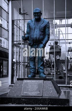 A traditional rendition of the statue of the famous Bolton steeplejack, Fred Dibnah in monochrome with pop colour Stock Photo