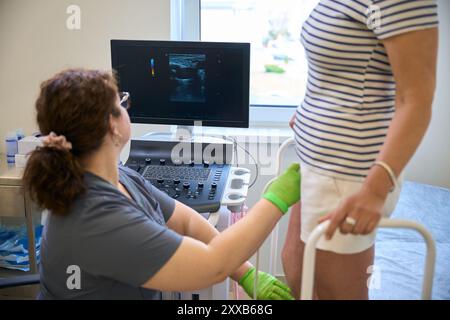 Woman doctor uses a modern ultrasound machine Stock Photo
