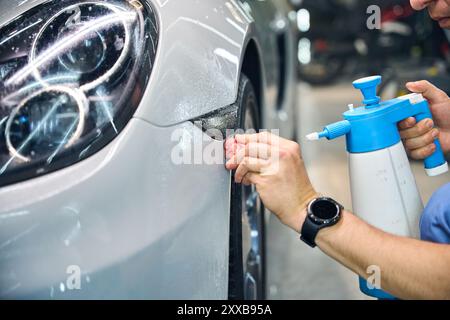 Worker uses special materials in process of detailing a car Stock Photo
