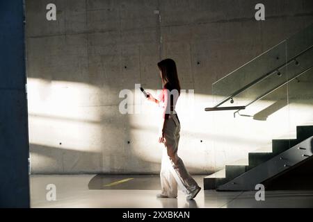 One woman, modern young woman with leather backpack in the underground pedestrian crossing in city. Stock Photo
