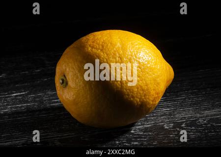 lemon on black wood background Stock Photo