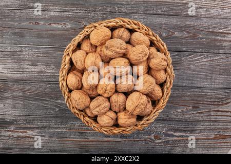 walnuts basket on wood background top view Stock Photo