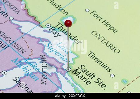 Close up to a Sault Ste Marie with a red pin needle into Canada country political map Stock Photo