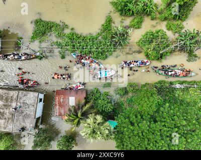 Dhaka, Bangladesh. 23rd Aug, 2024. An aerial view shows Volunteers rescue flood-affected residents in the Mohipal, area of Feni district in Chittagong division, Bangladesh, on August 23, 2024. At least 13 people are killed; a total of 43 upazilas in several districts are affected by the flash floods, and about 189,663 families are marooned. (Photo by /Sipa USA) Credit: Sipa USA/Alamy Live News Stock Photo