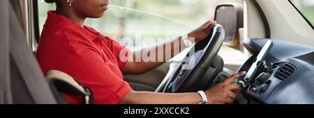 Header image with side view of unrecognizable female driver using smartphone in car Stock Photo