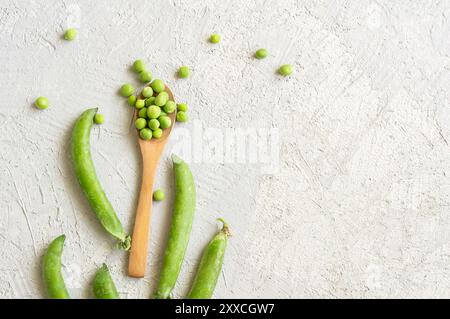 Fresh green peas with pod on wooden background, healthy green vegetable or legume ( pisum sativum ) Stock Photo