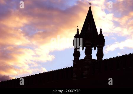 Dramatic black silhouette of a watch tower and a wall of The Kremlin in Moscow over colorful sunset sky Russia Stock Photo