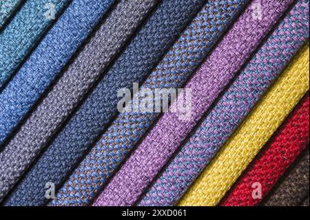 Colorful and bright fabric samples of furniture and clothing upholstery. Close-up of a palette of textile abstract stripes of different colors Stock Photo