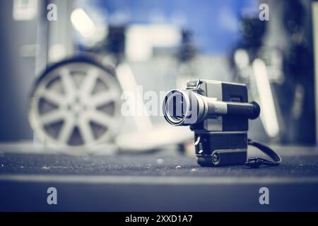 Vintage old movie camera, production studio in the blurry background Stock Photo