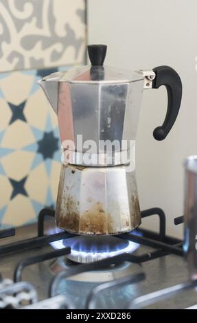 Close up of a blue gas flame, cooking a water pot in kitchen Stock Photo