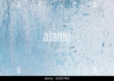 Textured metal surface carelessly colored blue paint and faded in the sun in pale gray with rusty specks. An old grunge texture on a metal surface Stock Photo