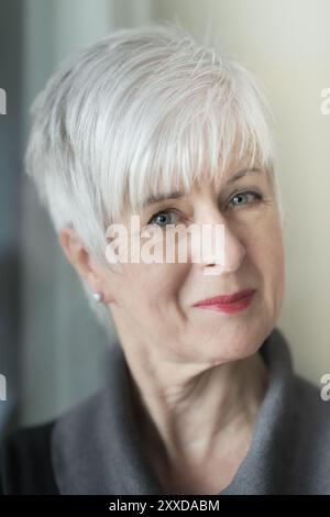 Portrait of a well-groomed-looking senior woman with short grey hair and a slight smile. Camera view Stock Photo