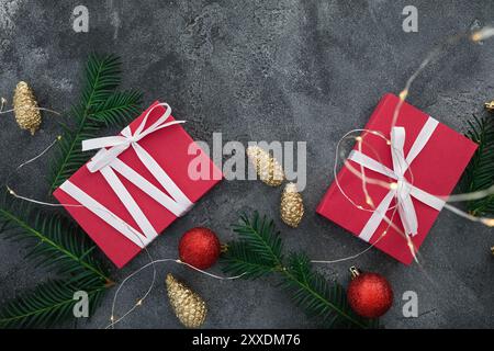 Christmas composition with branches, gifts and decoration on dark background. Flat lay Stock Photo