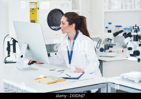 Computer, scientist and professional in science laboratory for medical research, biology and pharmaceuticals. Female person, technology and working in Stock Photo