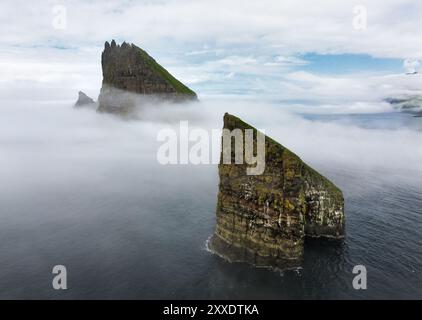 Faroe Islands Vagar, aerial drone view during sunset in North Atlantic Ocean. Faroe Islands, Denmark, Europe. Drangarnir and Tindholmur Stock Photo