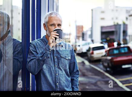 Portrait, takeaway coffee and mature man in city, drinking and calm with morning routine in street. Face, person and traveller with herbal tea on Stock Photo