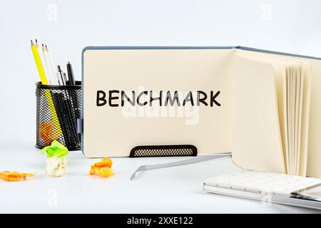 Business concept of benchmark. A word BENCHMARK written on a blank sheet of notepad in the stand Stock Photo