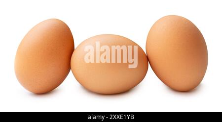 Three fresh brown chicken eggs in stack are isolated on white background with clipping path. Stock Photo