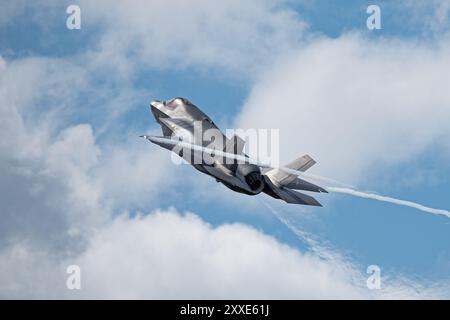 Old Buckenham, UK, July 27 2024: RAF F-35B fighter jet aircraft in flight at the airshow. Climbing fighter jet with vapour trails and heat haze Stock Photo