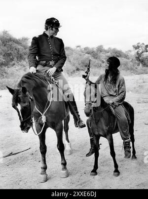 CHARLTON HESTON and his son FRASER HESTON (dressed as a Native American) on set candid during location filming in Mexico of MAJOR DUNDEE 1965 director SAM PECKINPAH story Harry Julian Fink screenplay Harry Julian Fink Oscar Saul and Sam Peckinpah Jerry Bresler Productions / Columbia Pictures Stock Photo