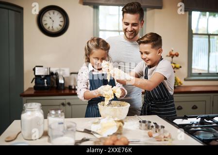 Cooking, dough and children with father in kitchen for learning, development or skill growth. Happy, bonding and kids with dad for preparing pizza Stock Photo