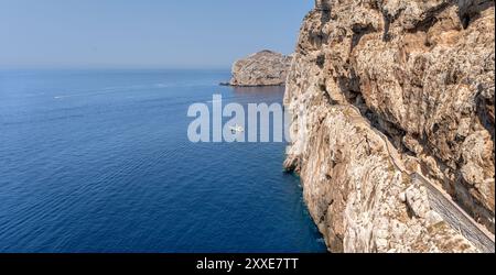 Spectacular seascape of the great cliff with access to the Neptune's Grotto (Grotta di Nettuno) dug in the middle of the cliff in Sardinia, overlookin Stock Photo