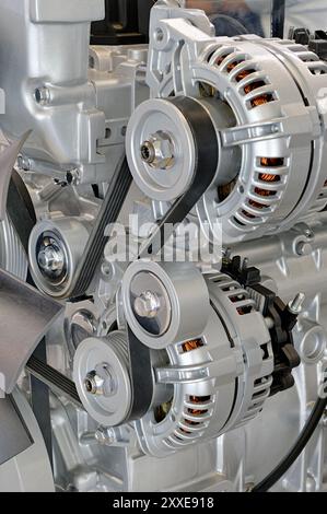 Modern internal combustion engine, close up shot. External parts visible - generator, drive belt, pulleys and idlers Stock Photo